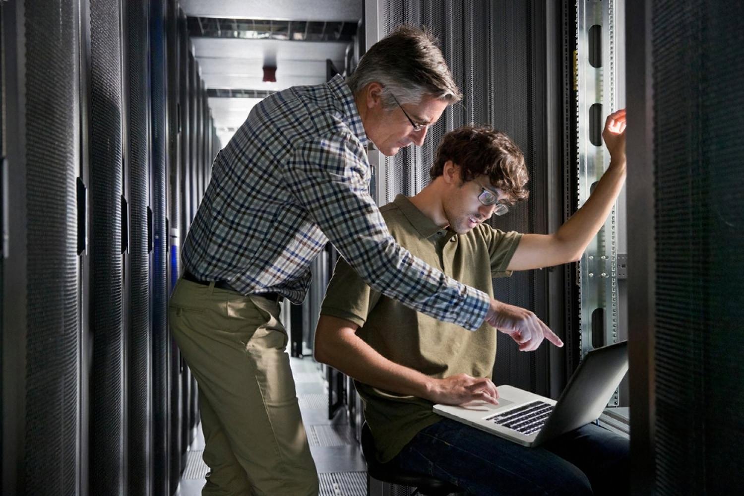 Two engineers reviewing website server infrastructure in a UAE data centre