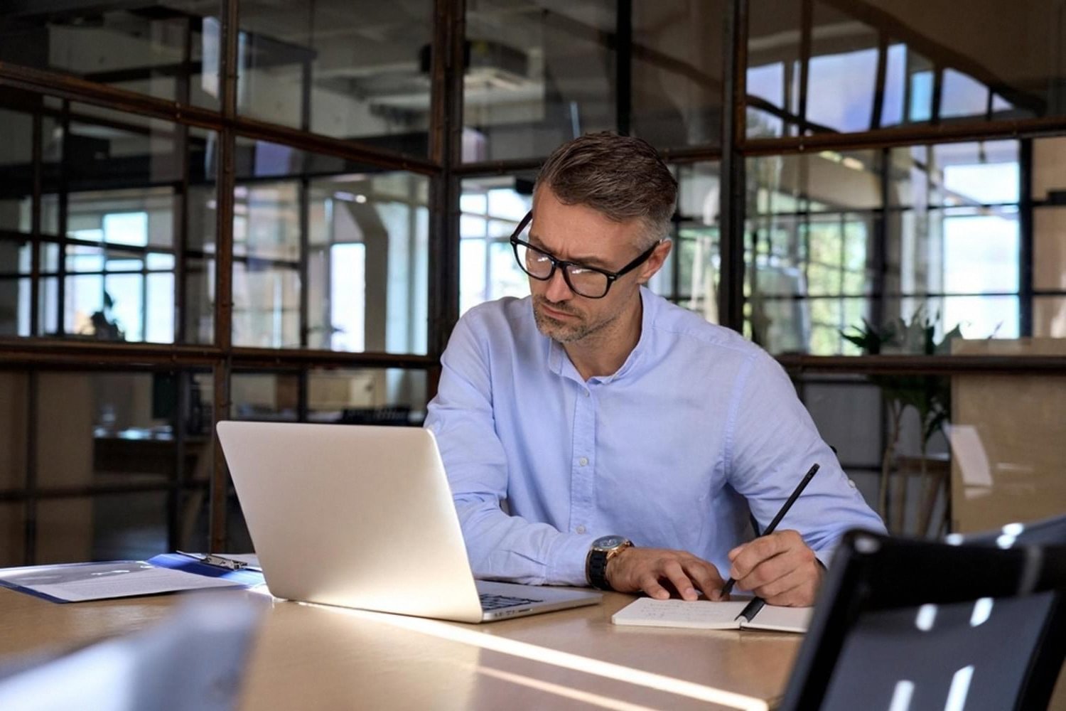 Business owner reviewing UBO compliance records on a laptop in a UAE office